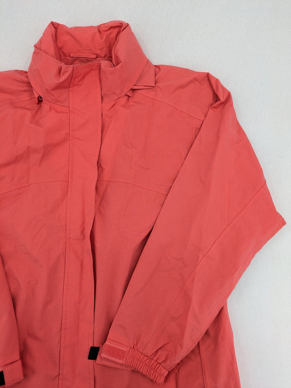 Black Bear black rain jacket with coral pink mesh lining and full zipper.