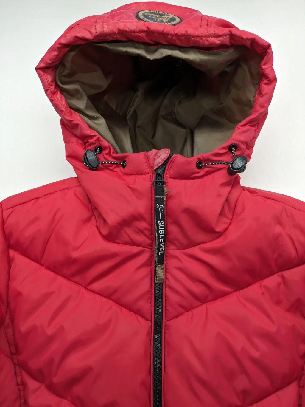 Sublevel red puffer jacket size S, chevron quilted pattern, adjustable hood, recycled polyester lining.