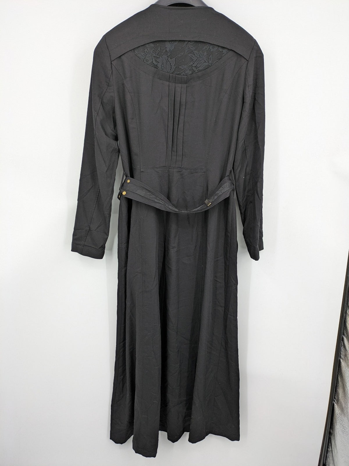 Alvina black trench coat with lace collar and gold buttons, belted waist design.