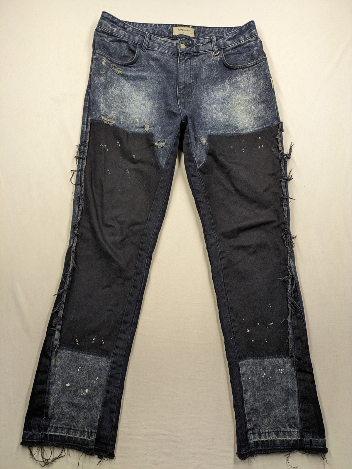 Reternity straight jeans blue black patchwork design with distressed details and frayed seams.