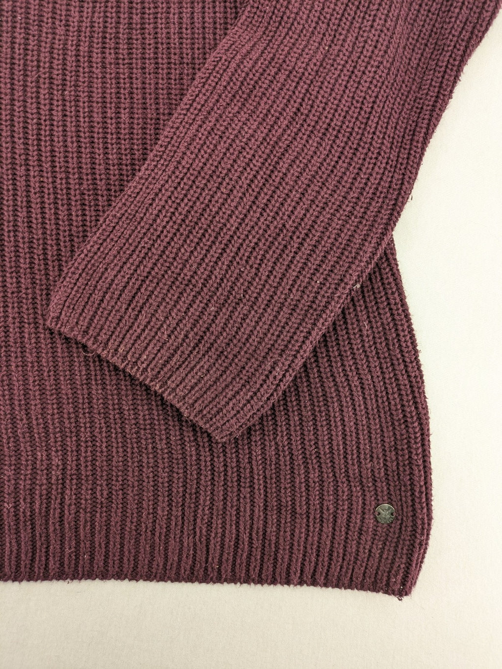Monari burgundy knit jumper with standing collar, ribbed texture, and raglan sleeves.