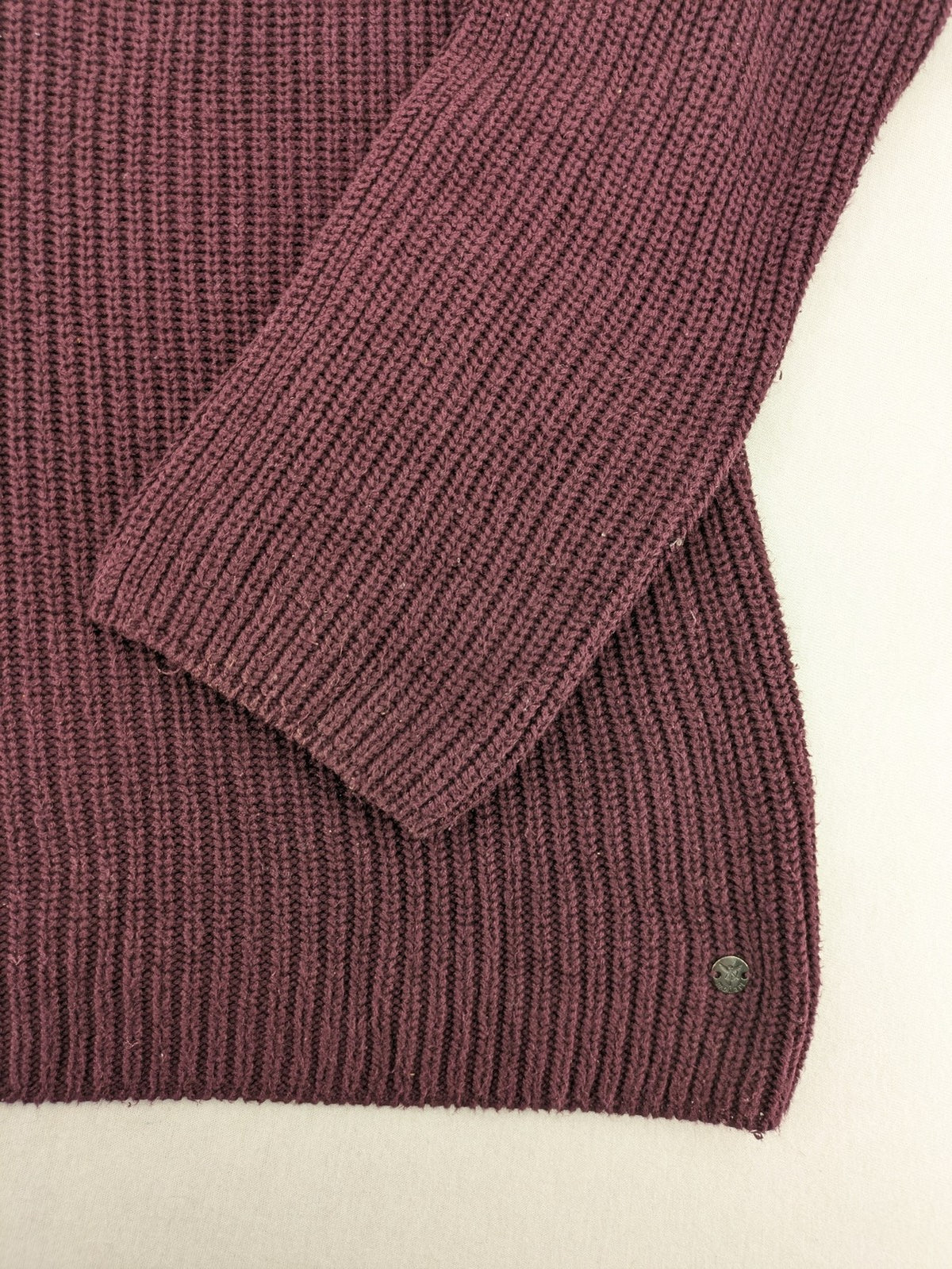 Monari burgundy knit jumper with standing collar, ribbed texture, and raglan sleeves.
