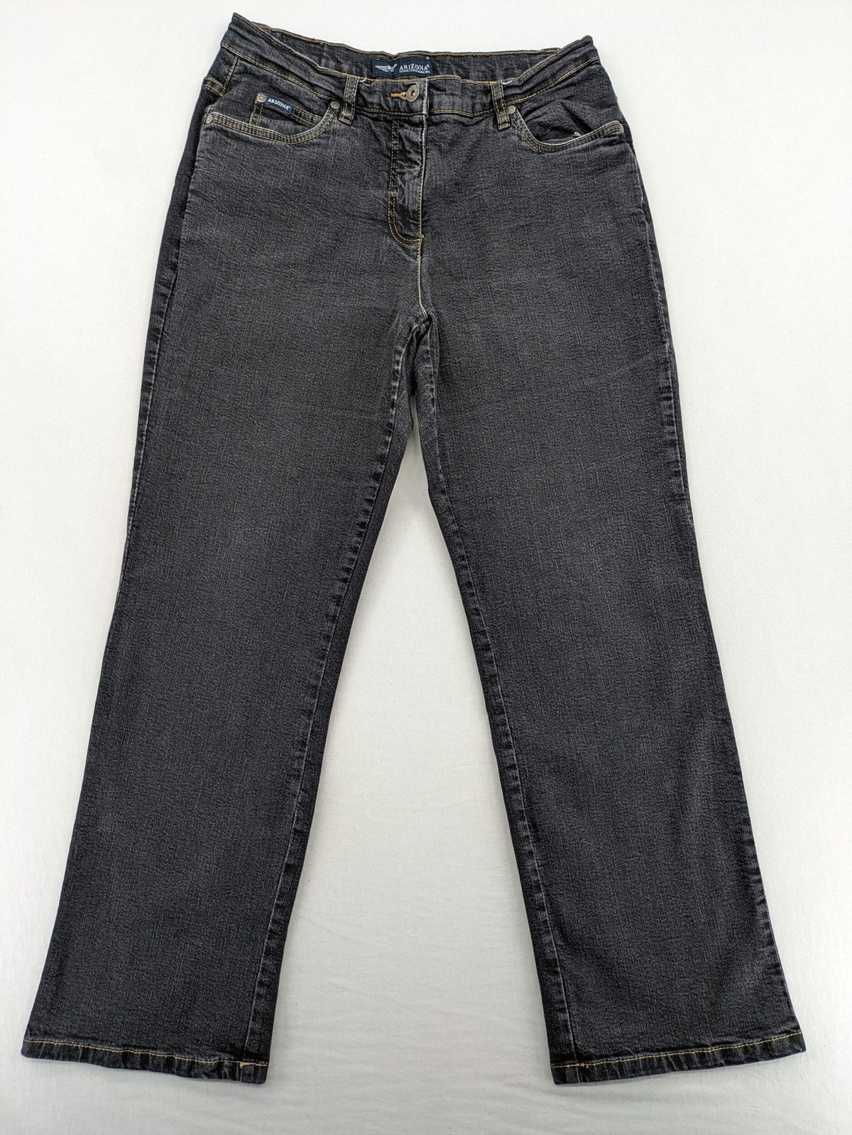 Bootcut grey low rise bootcut jeans five-pocket design with zipper and button closure.