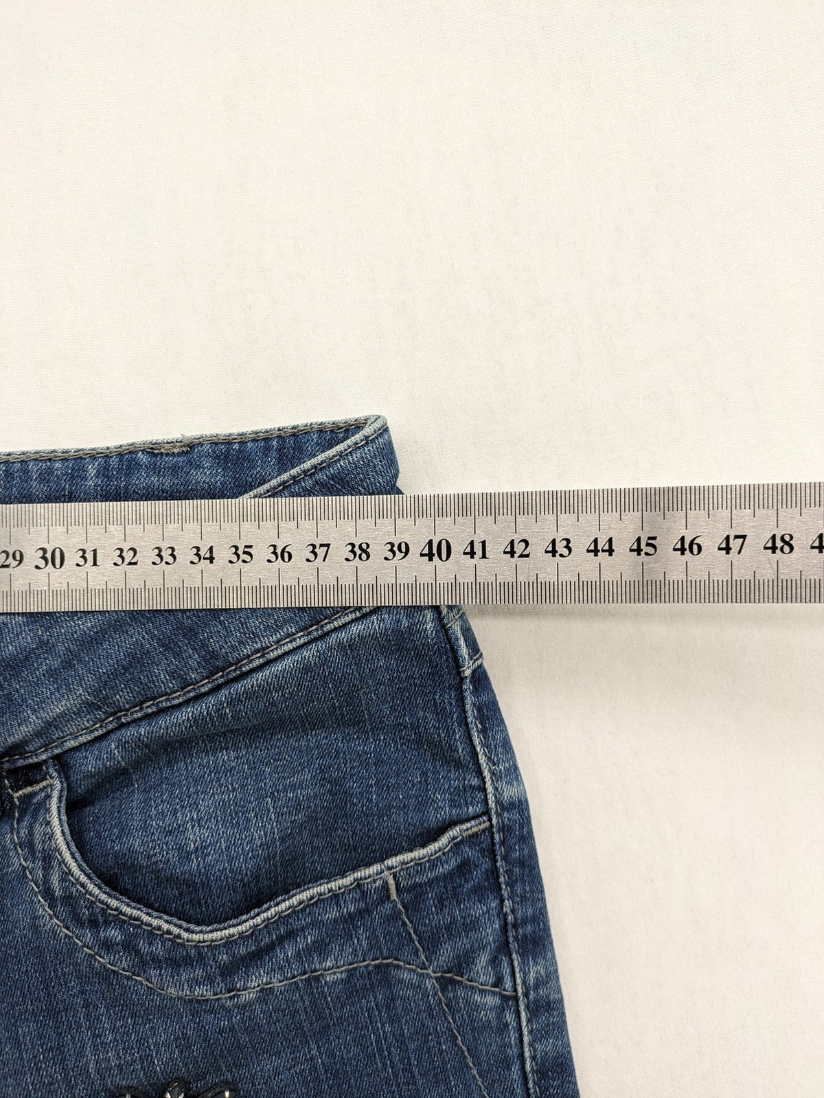 Gerry Weber blue straight jeans with decorative rhinestone appliqués and stretch denim material.