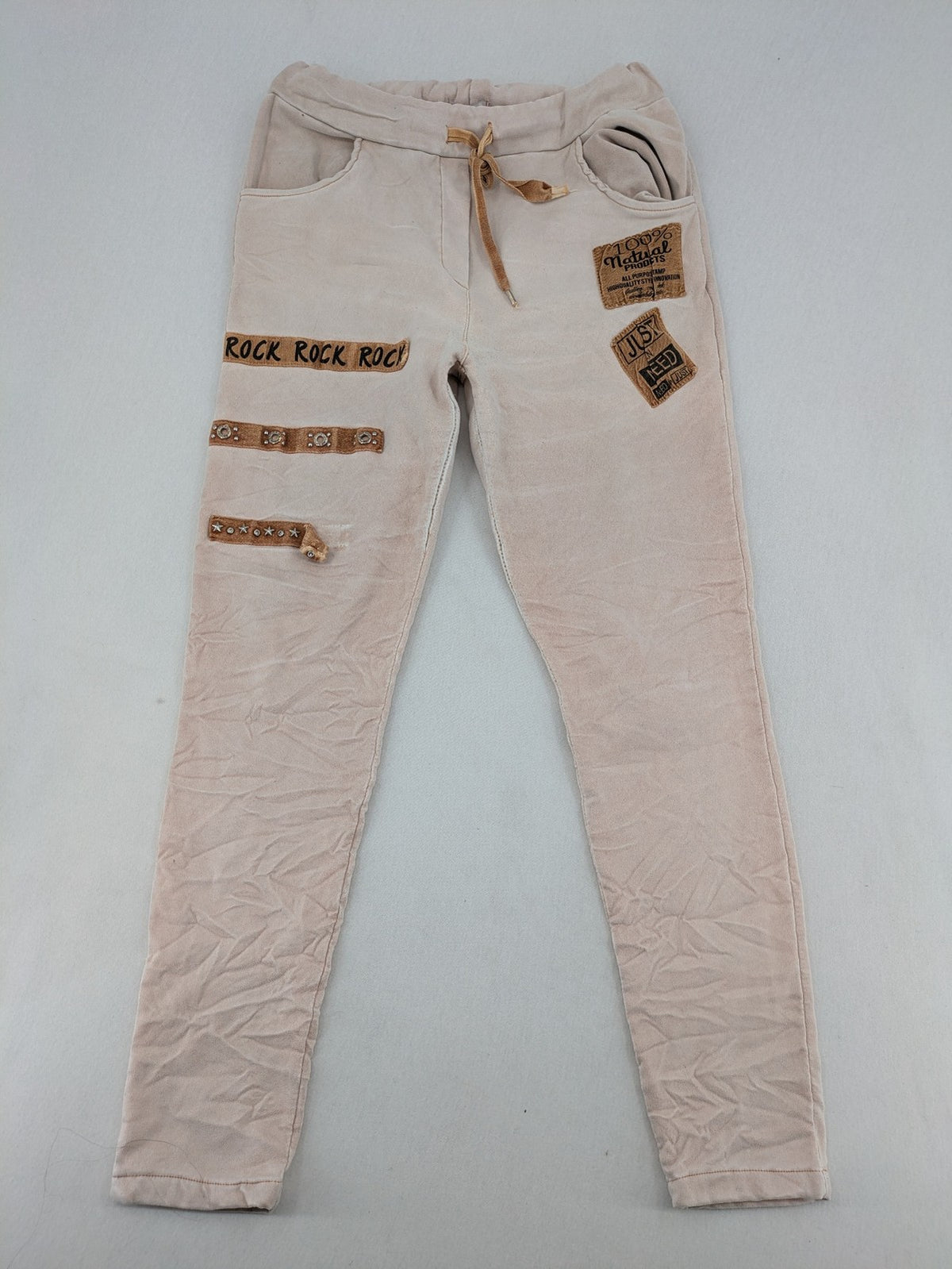 Made In Italy beige pants with crinkle texture and rock-style patches, drawstring waist.