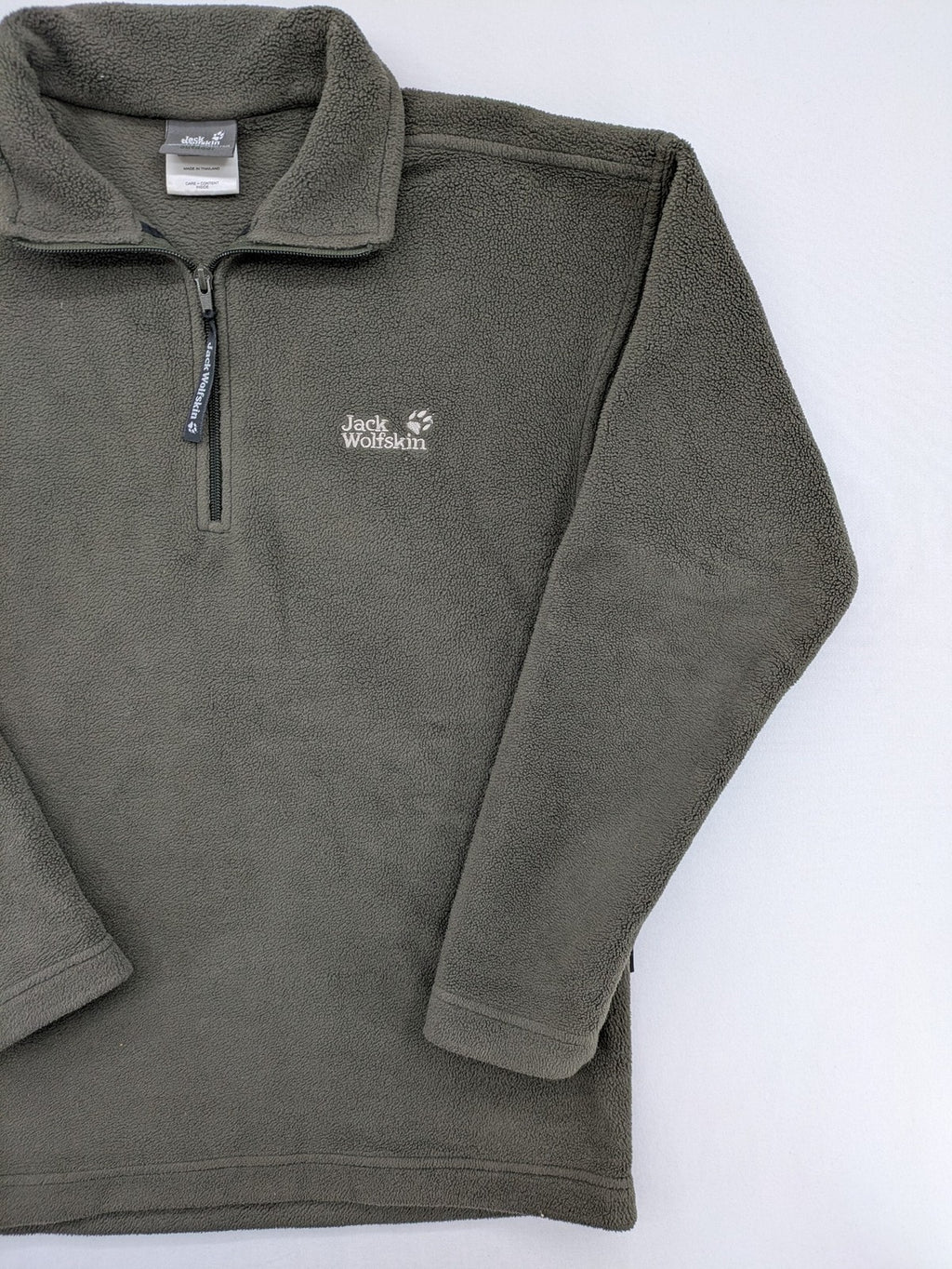 Jack Wolfskin khaki turtle neck jumper with quarter zip and embroidered paw logo.