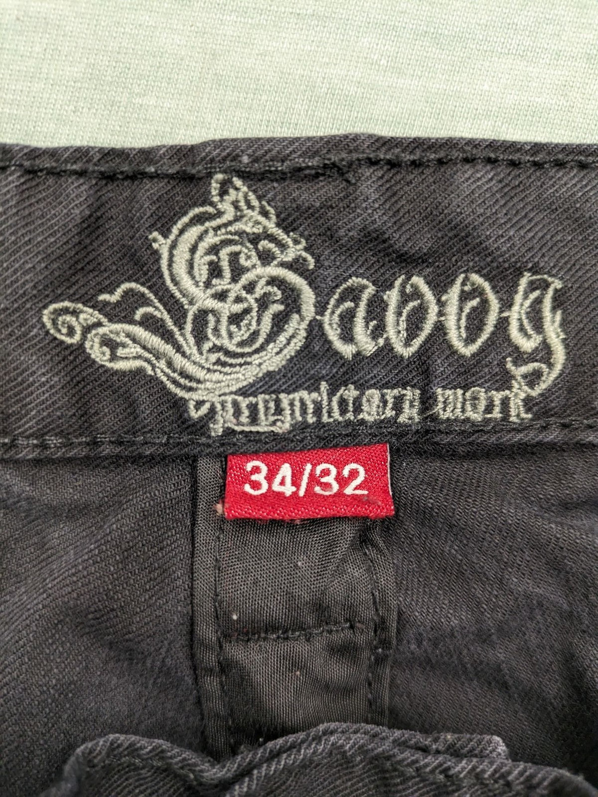 Savvy black pants straight fit with button fly, embroidered details and unique stitching.