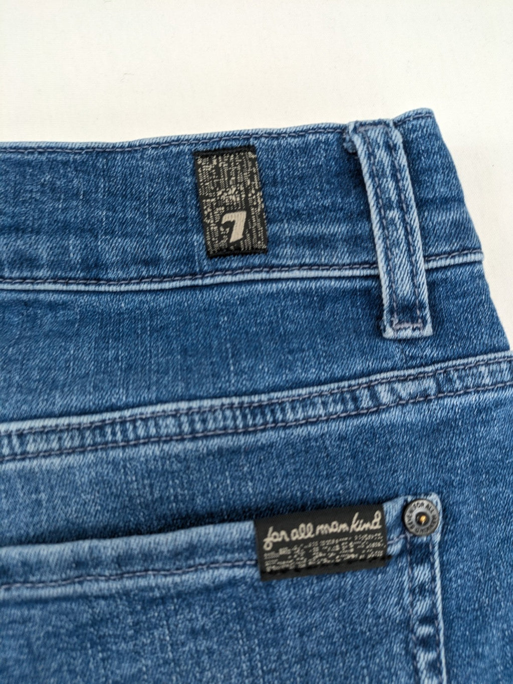 7 For All Mankind blue straight jeans with 5-pocket design and logo on back pocket.