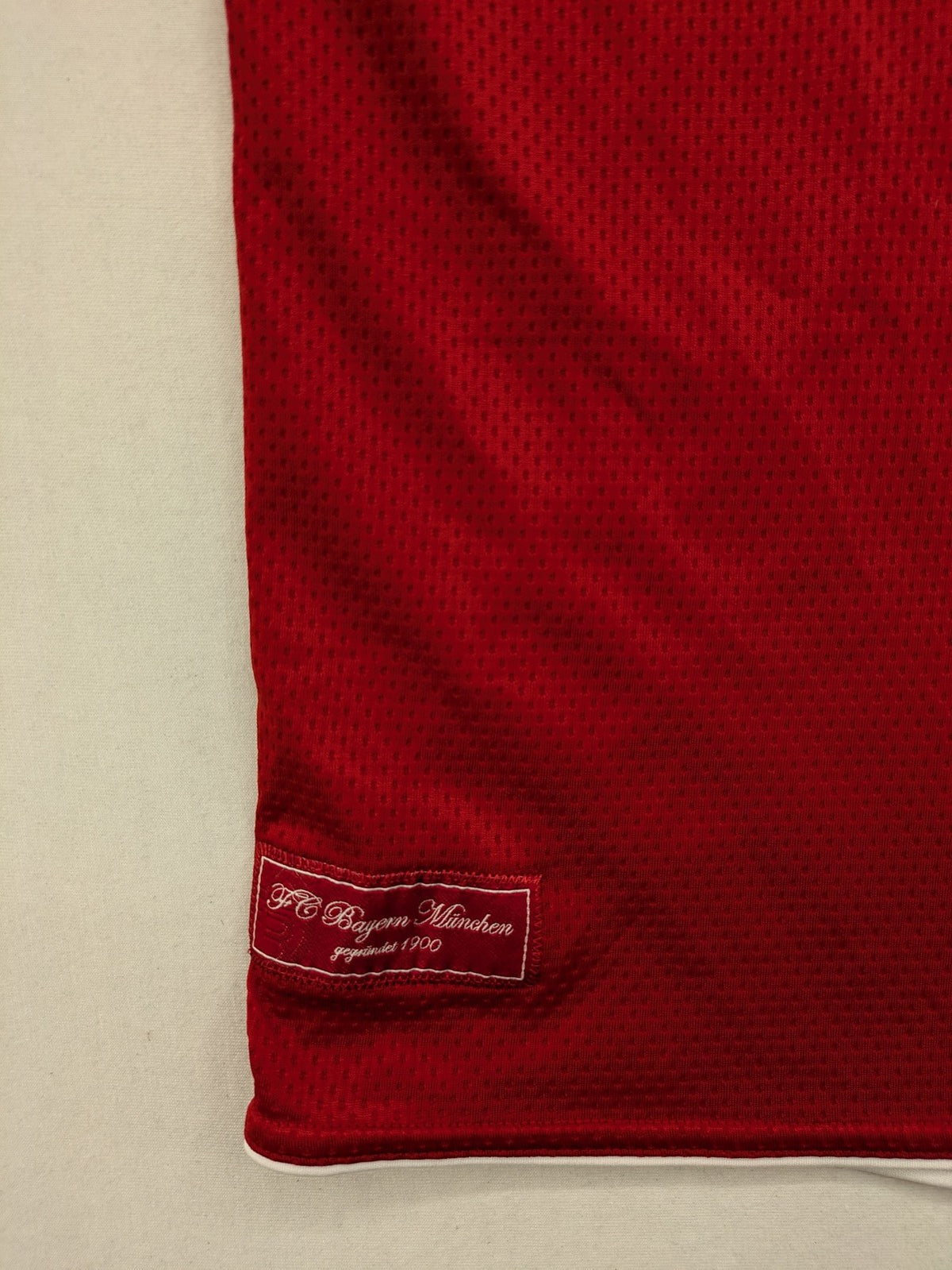 Adidas red soccer uniform with T-Home logo and embroidered FC Bayern München crest.