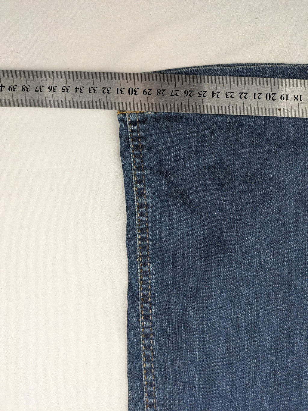Rosner blue wide leg jeans with colorful embroidery on back pockets.