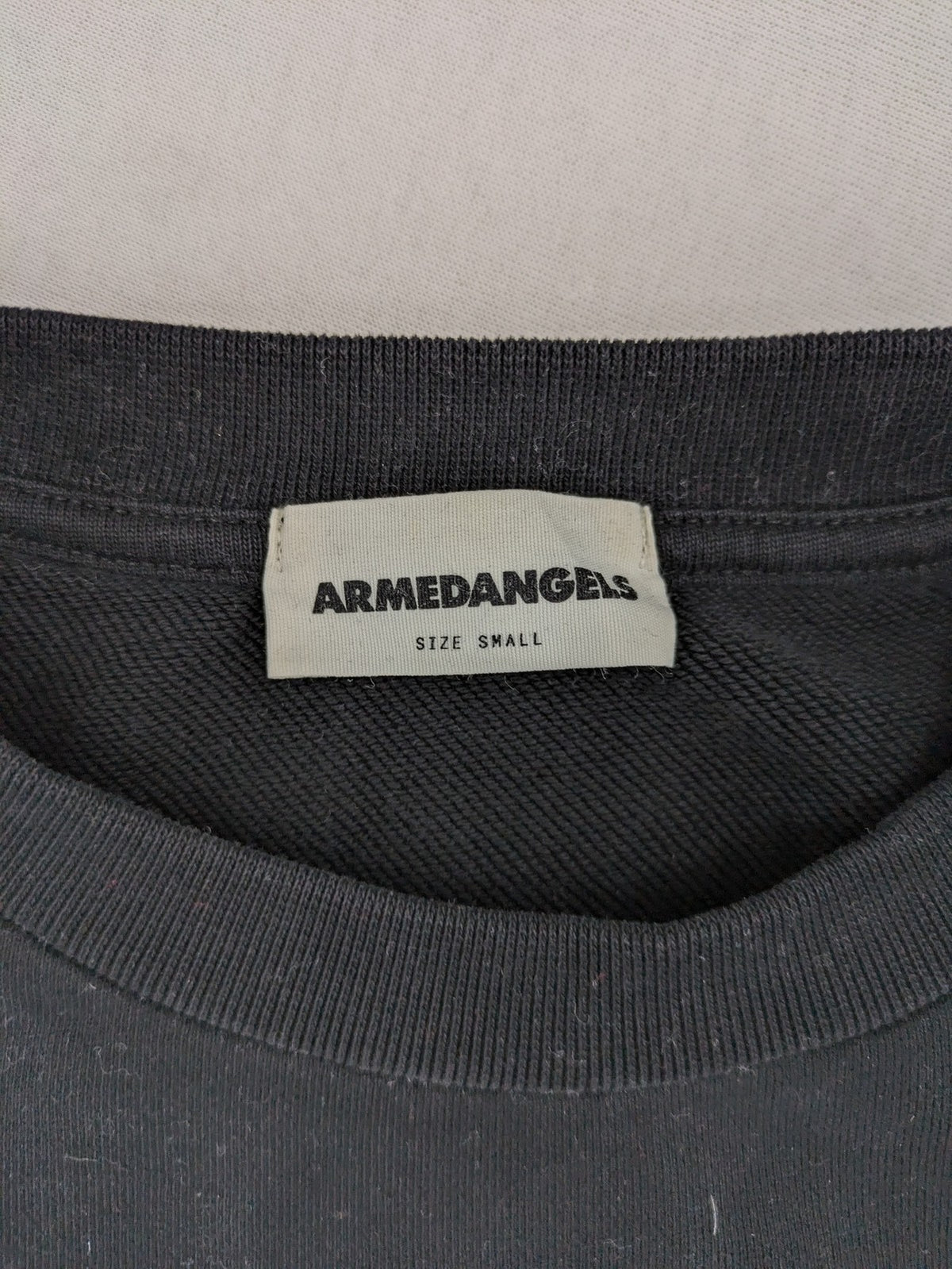 Armedangels black turtle neck jumper with embroidered logo, made from 100% organic cotton.