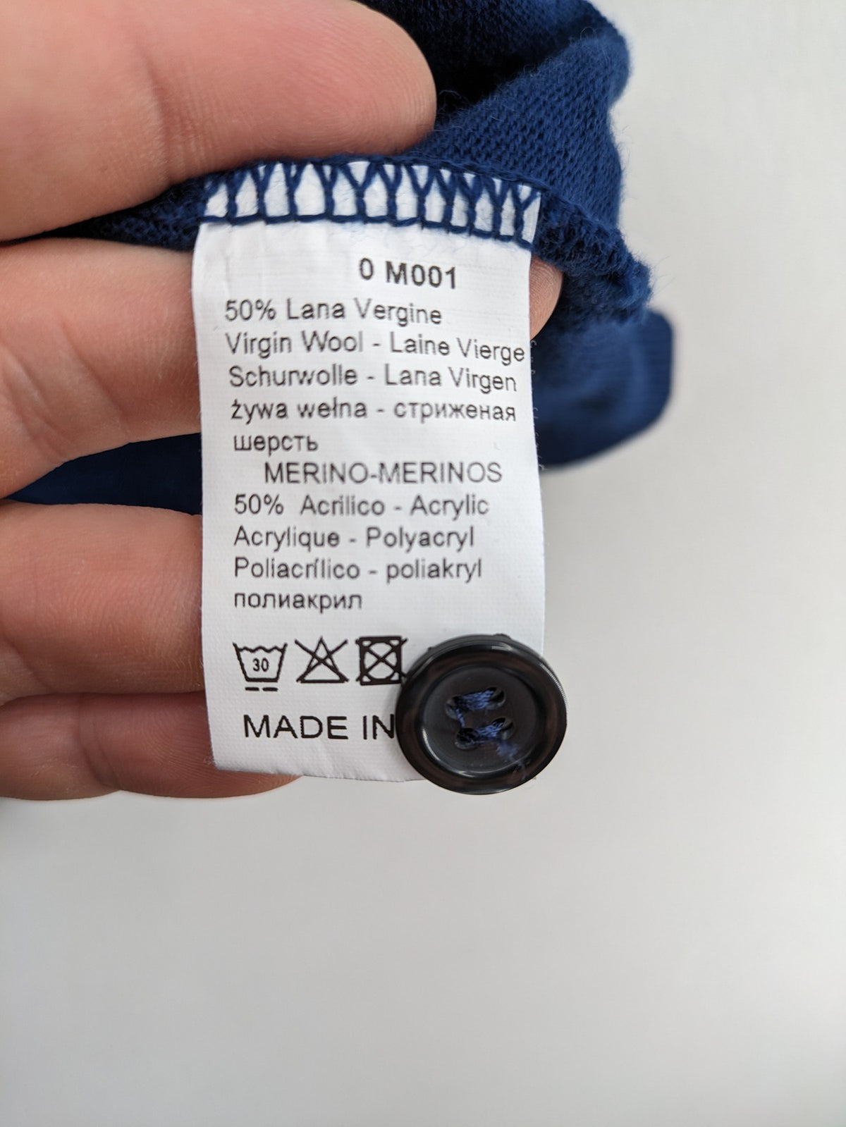 Montechiaro blue turtle neck jumper with V-neck, button placket, and sleeveless design.
