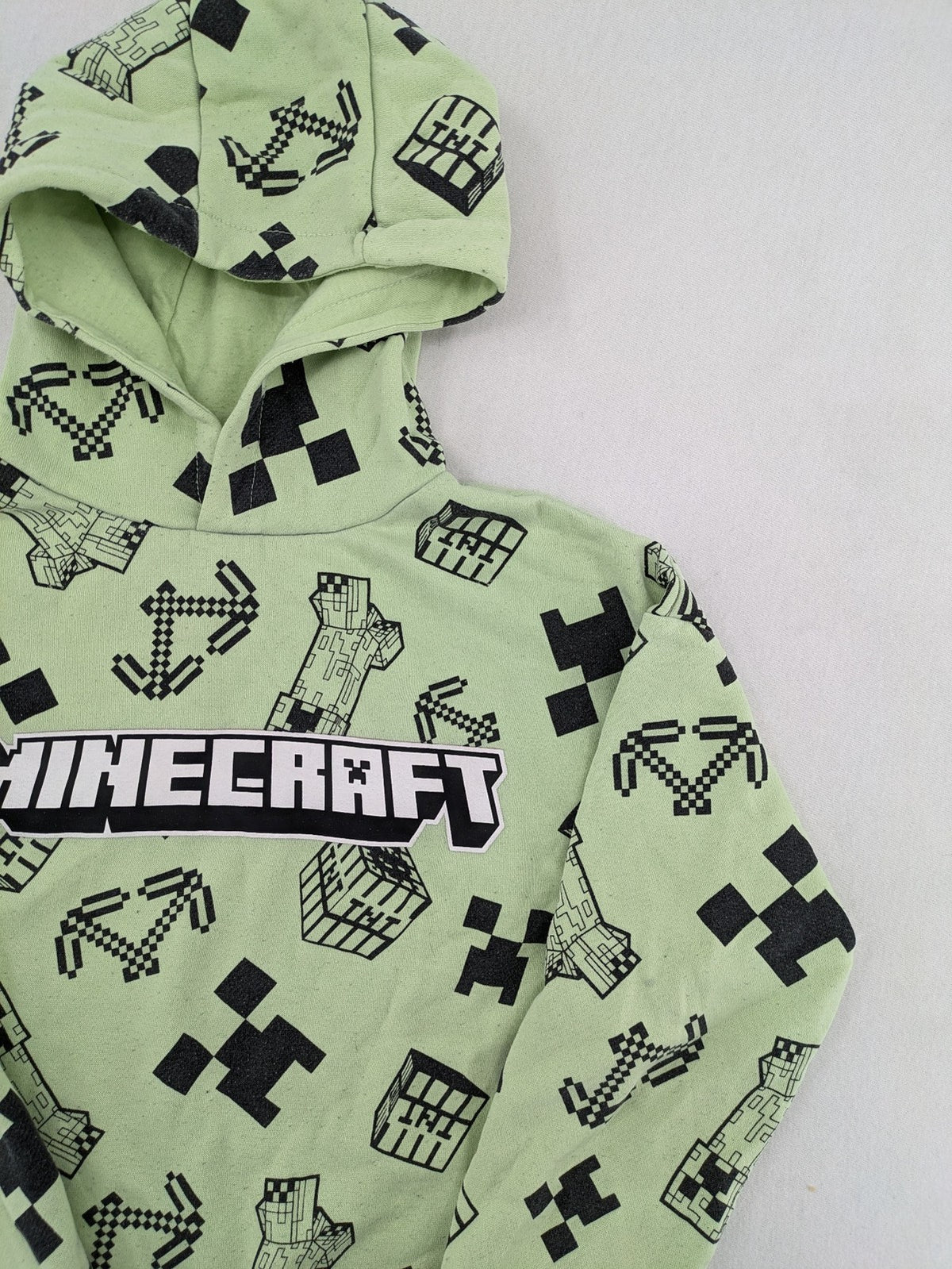 Minecraft zip-through hoodie green all-over print with Creeper and logo details.
