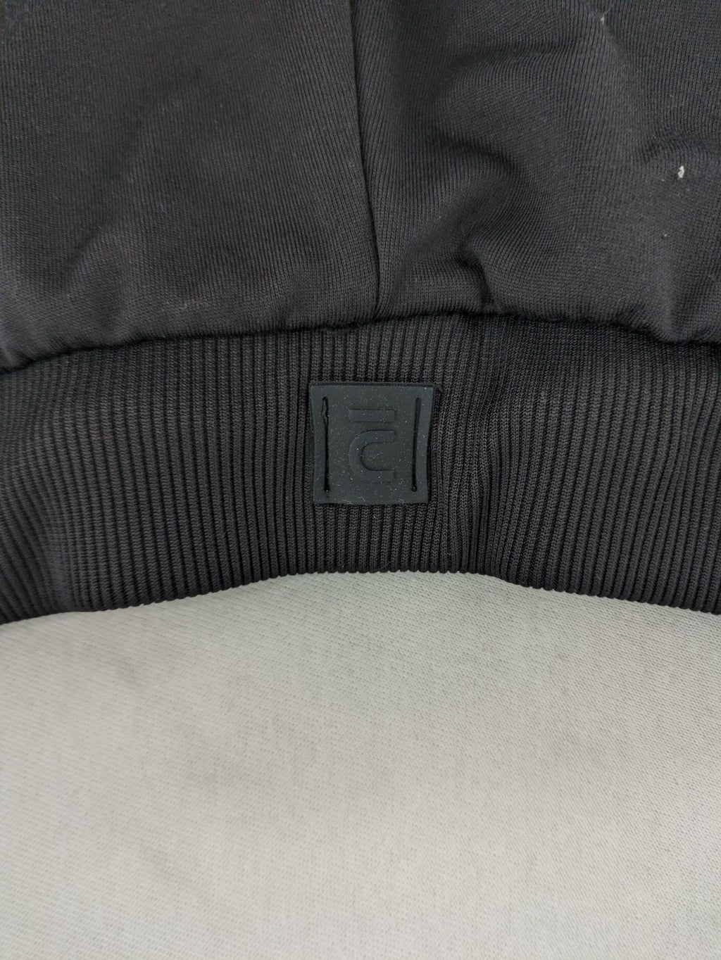 Kalenji black loungewear pants with grey accents and zippered side pockets.