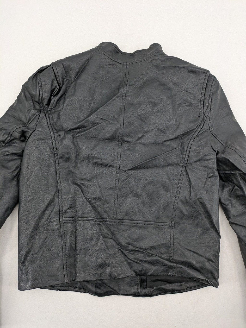 H&M black biker jacket with silver zippers, shoulder flaps, and snap-button details.