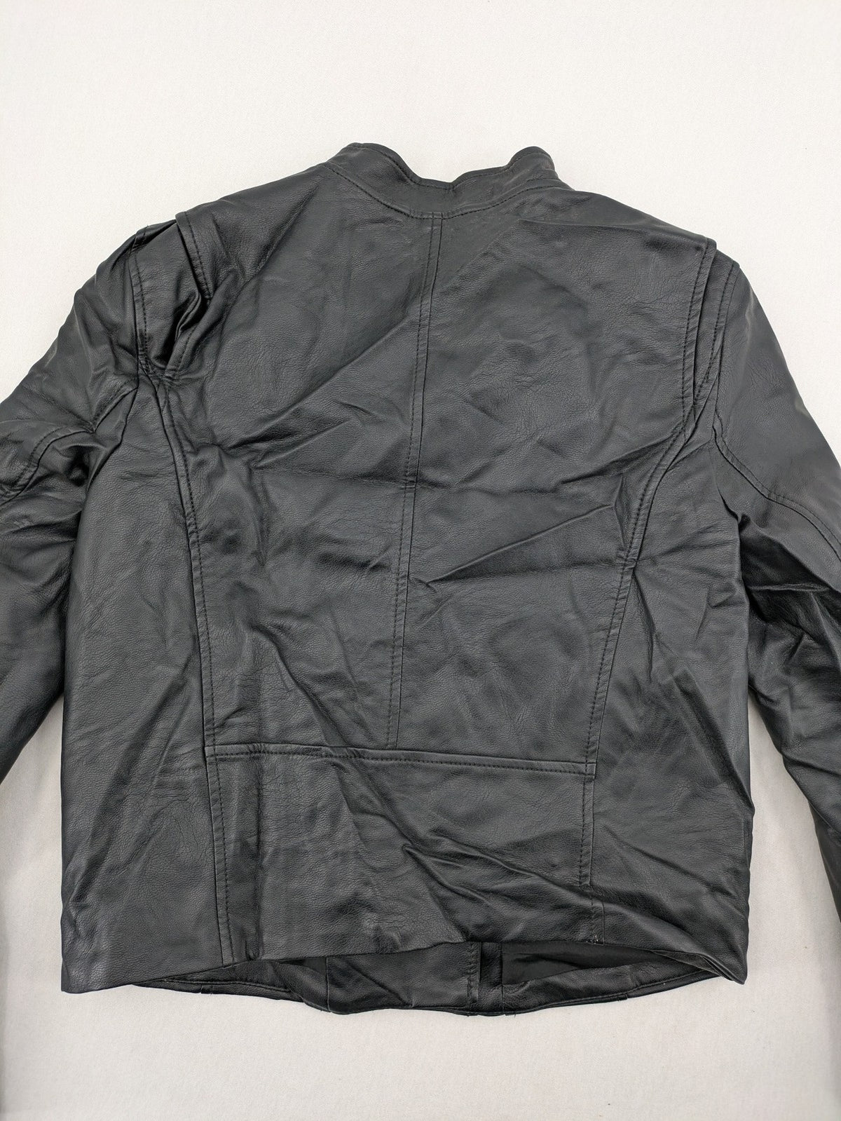 H&M black biker jacket with silver zippers, shoulder flaps, and snap-button details.