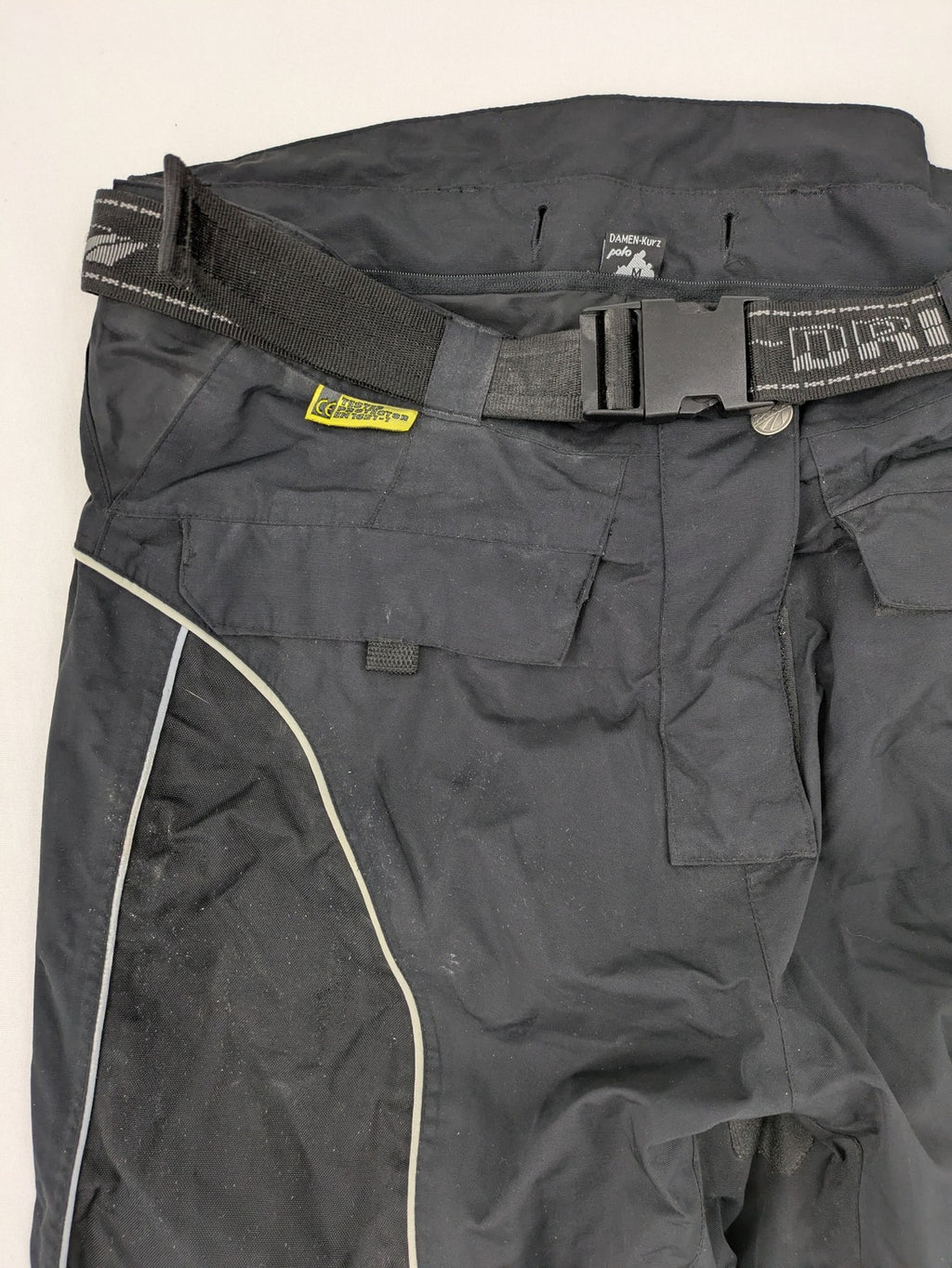 Polo black chaps with grey and white accents, featuring protective knee pads and adjustable belt.