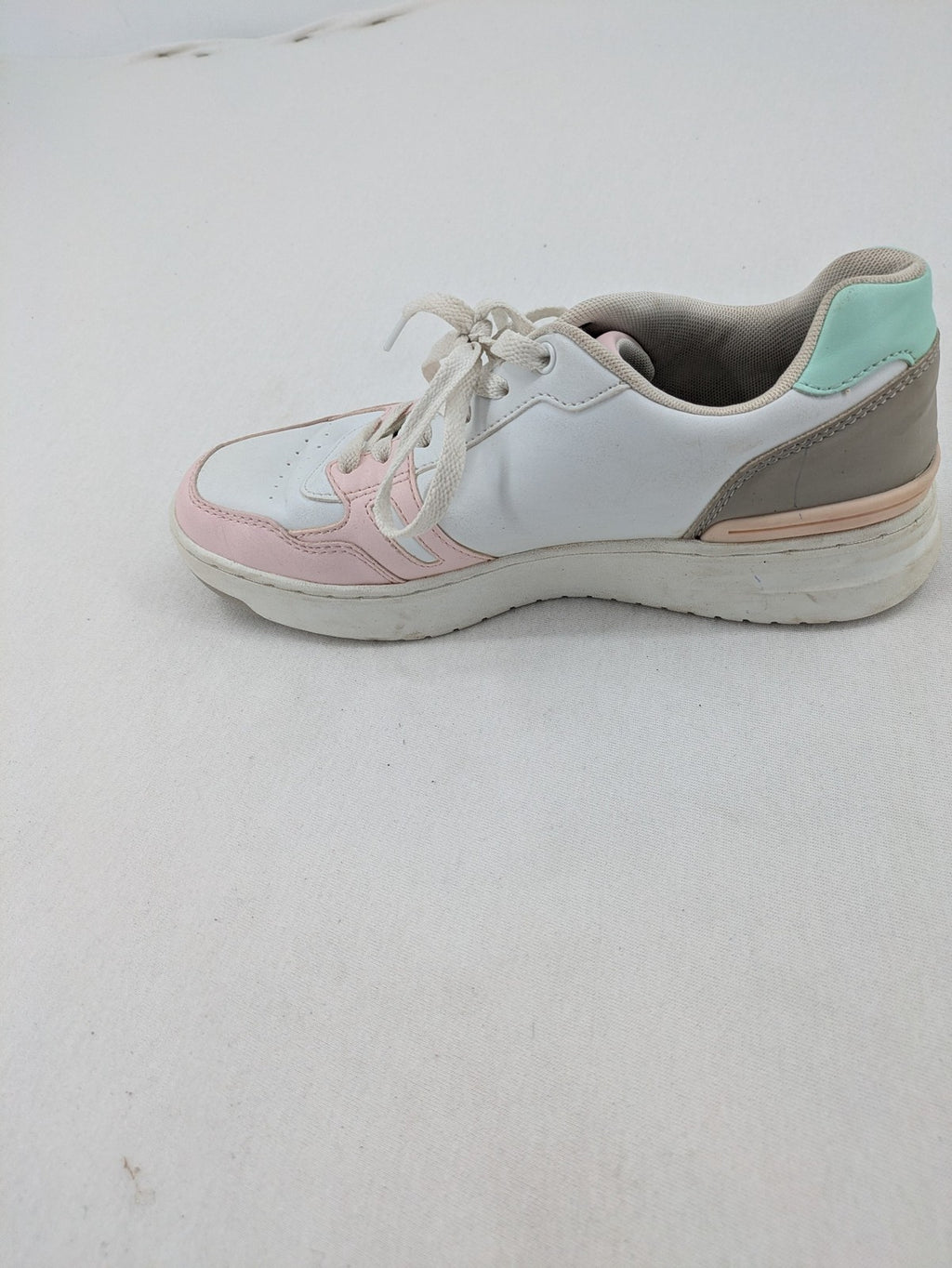 Graceland white sneakers with pink and mint green accents, low-top design, cushioned tongue.
