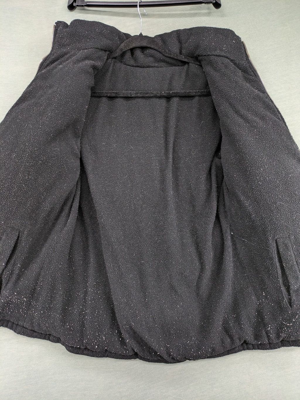 Puffer grey and red jacket with fleece lining, front zipper, and side pockets.