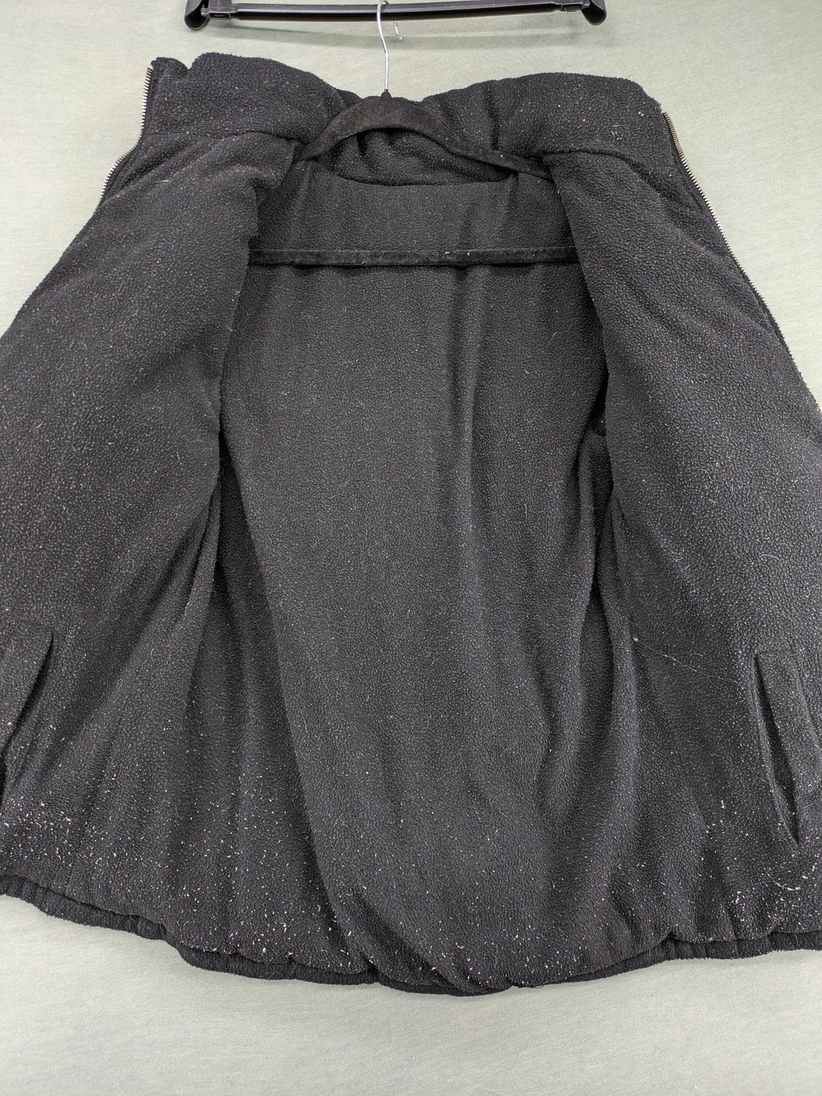 Puffer grey and red jacket with fleece lining, front zipper, and side pockets.