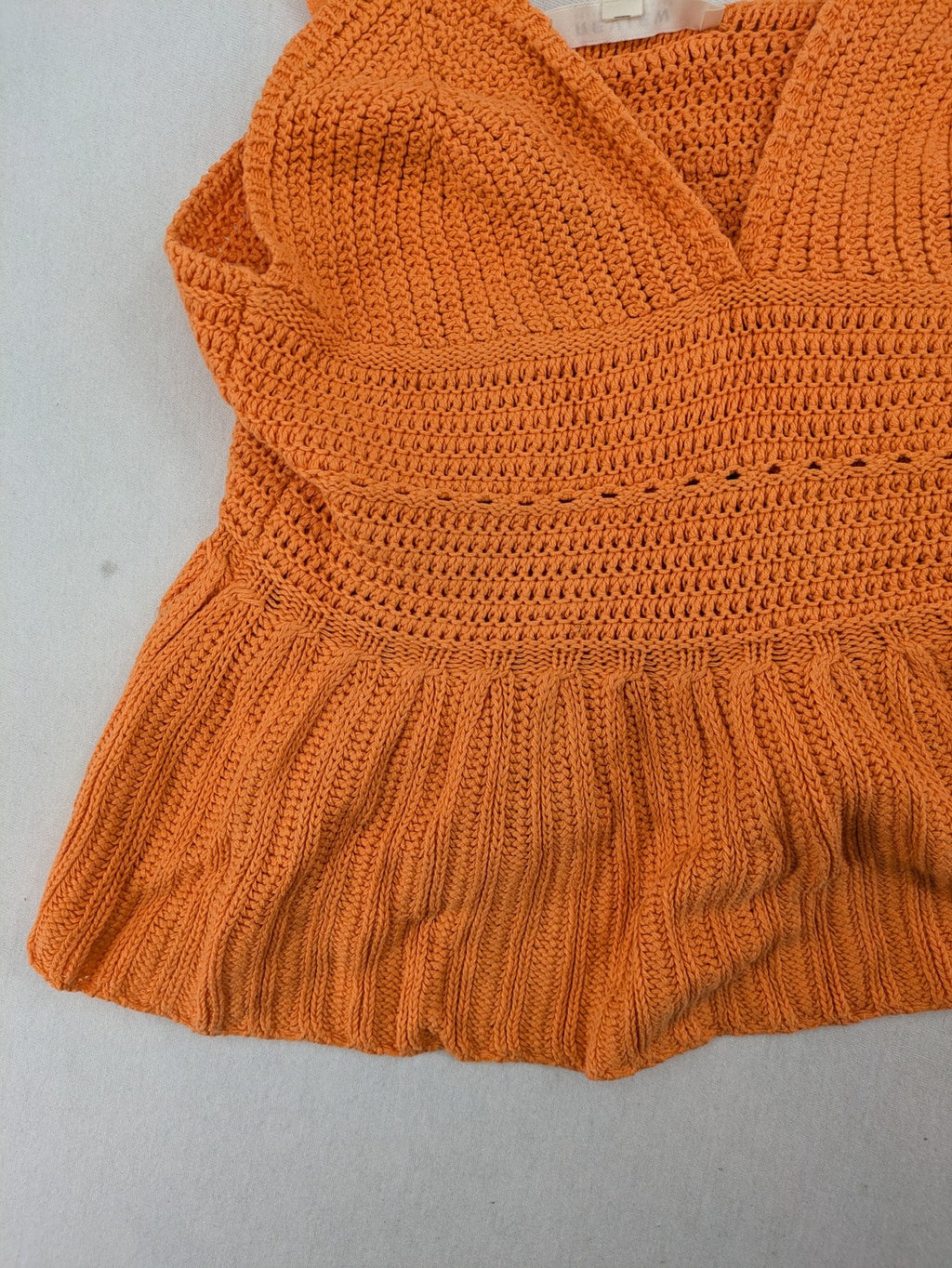 REVIEW orange crochet top with V-neck and peplum hem, made from 100% cotton.