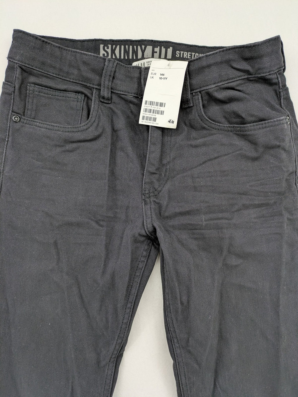 H&M grey skinny fit stretch jeans with modern design and durable denim material.