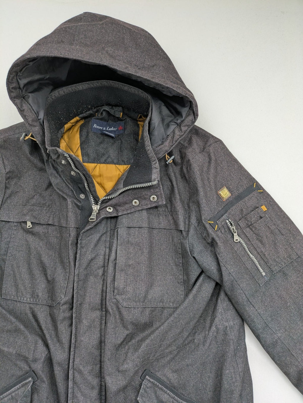 Rover & Lakes grey jacket with hood, quilted lining, and multiple pockets.