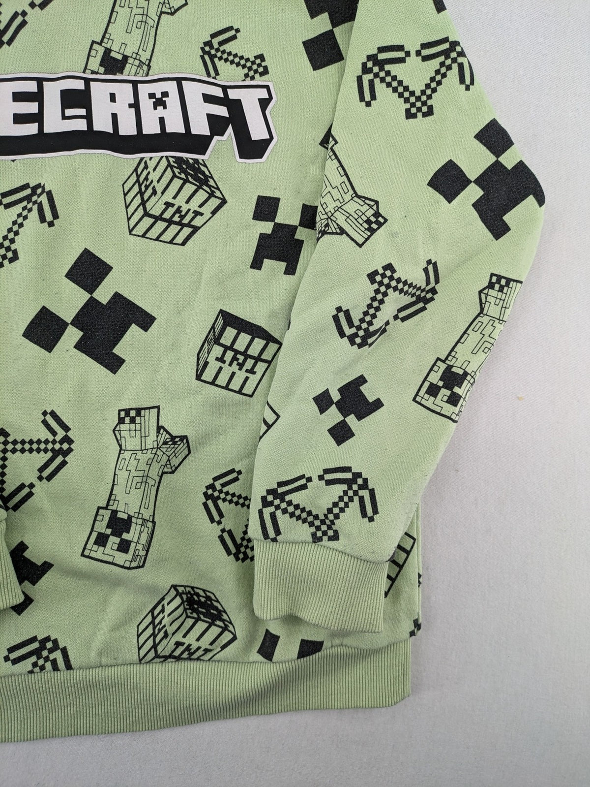 Minecraft zip-through hoodie green all-over print with Creeper and logo details.