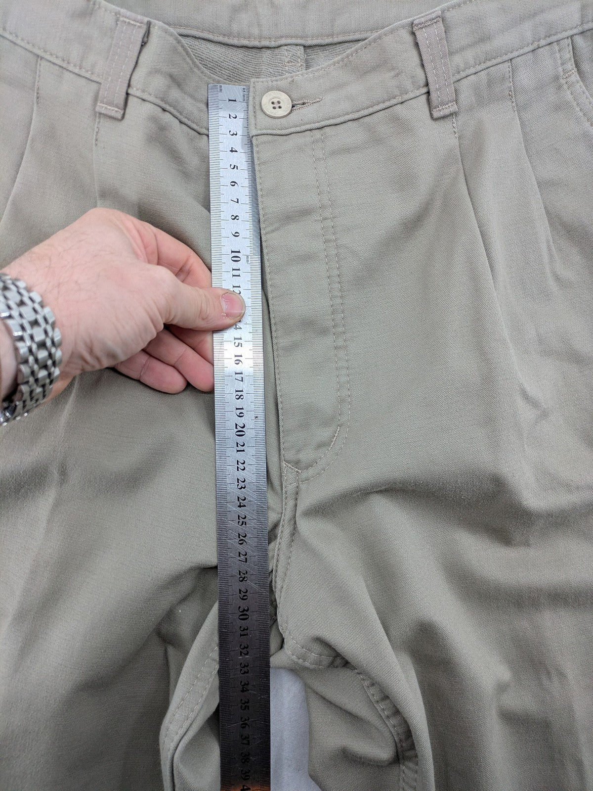 Pioneer beige chino trousers with pleats, straight leg, and buttoned back pocket.