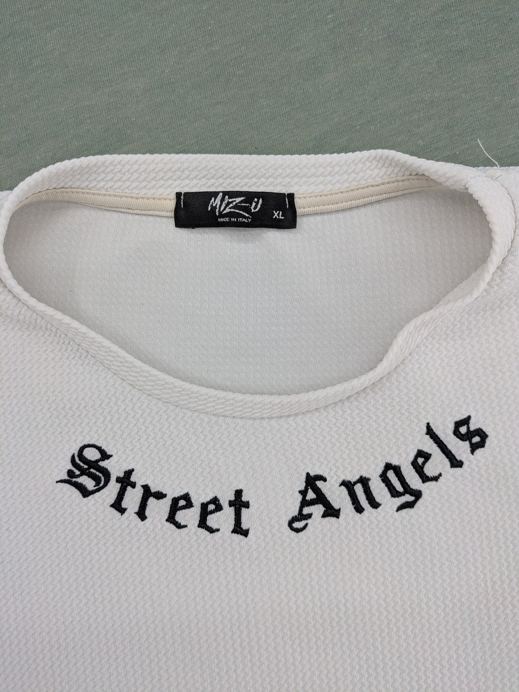 MIZ-U white longline t-shirt with "Street Angels" embroidery and rolled sleeves.