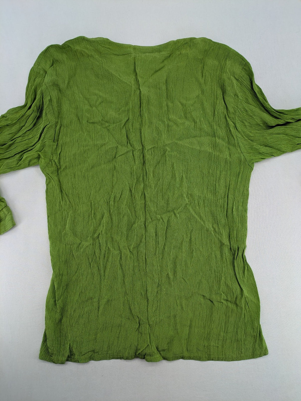 Expressions green blouse with V-neck, button front, and crinkle texture.