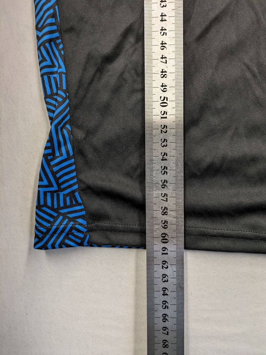 Puma black performance T-shirt with blue geometric side panels and iconic logo.