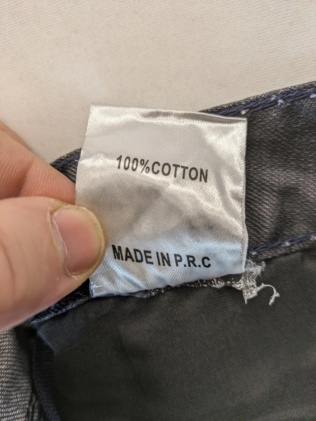 Fadnoble grey straight jeans with button fly and contrasting stitching details.