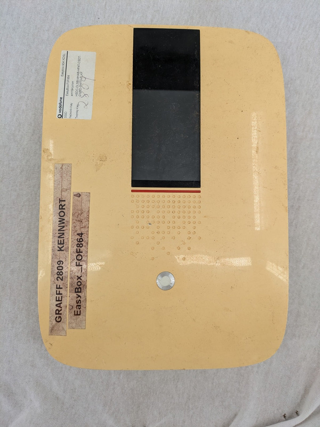 Vodafone wireless router beige and black with multiple LAN ports and USB connection.