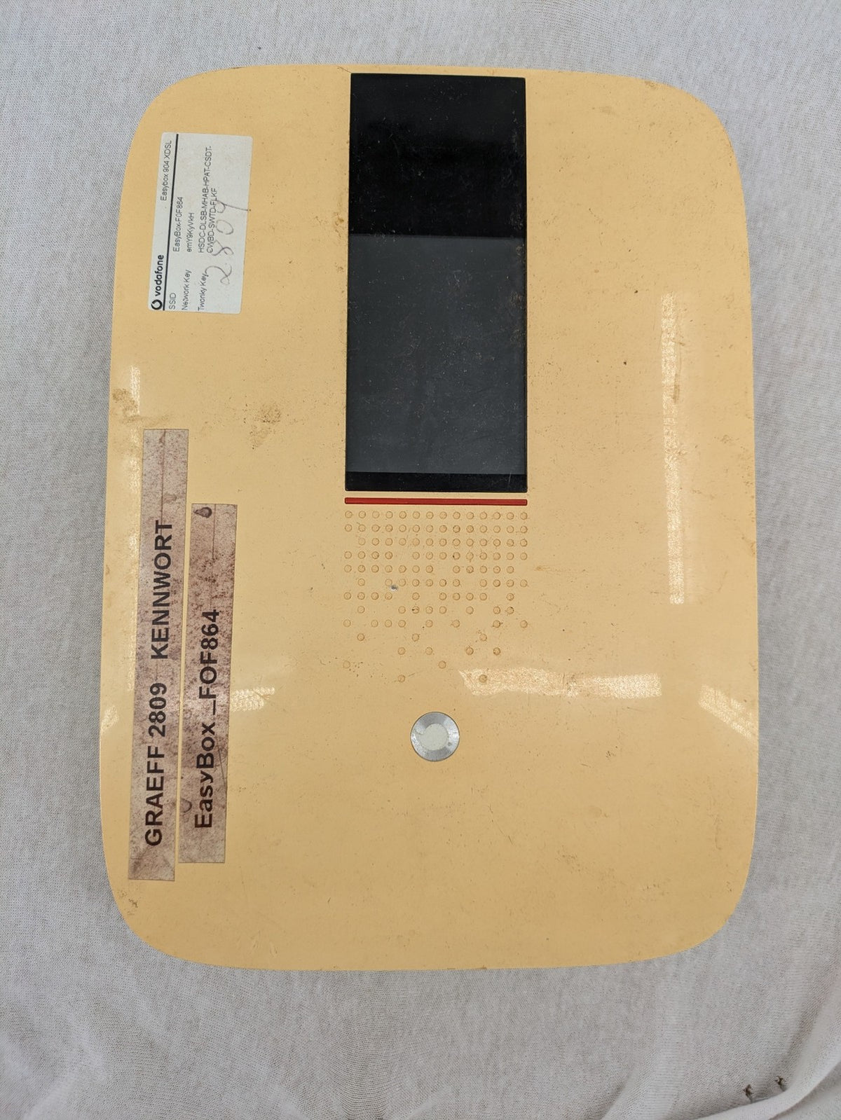 Vodafone wireless router beige and black with multiple LAN ports and USB connection.