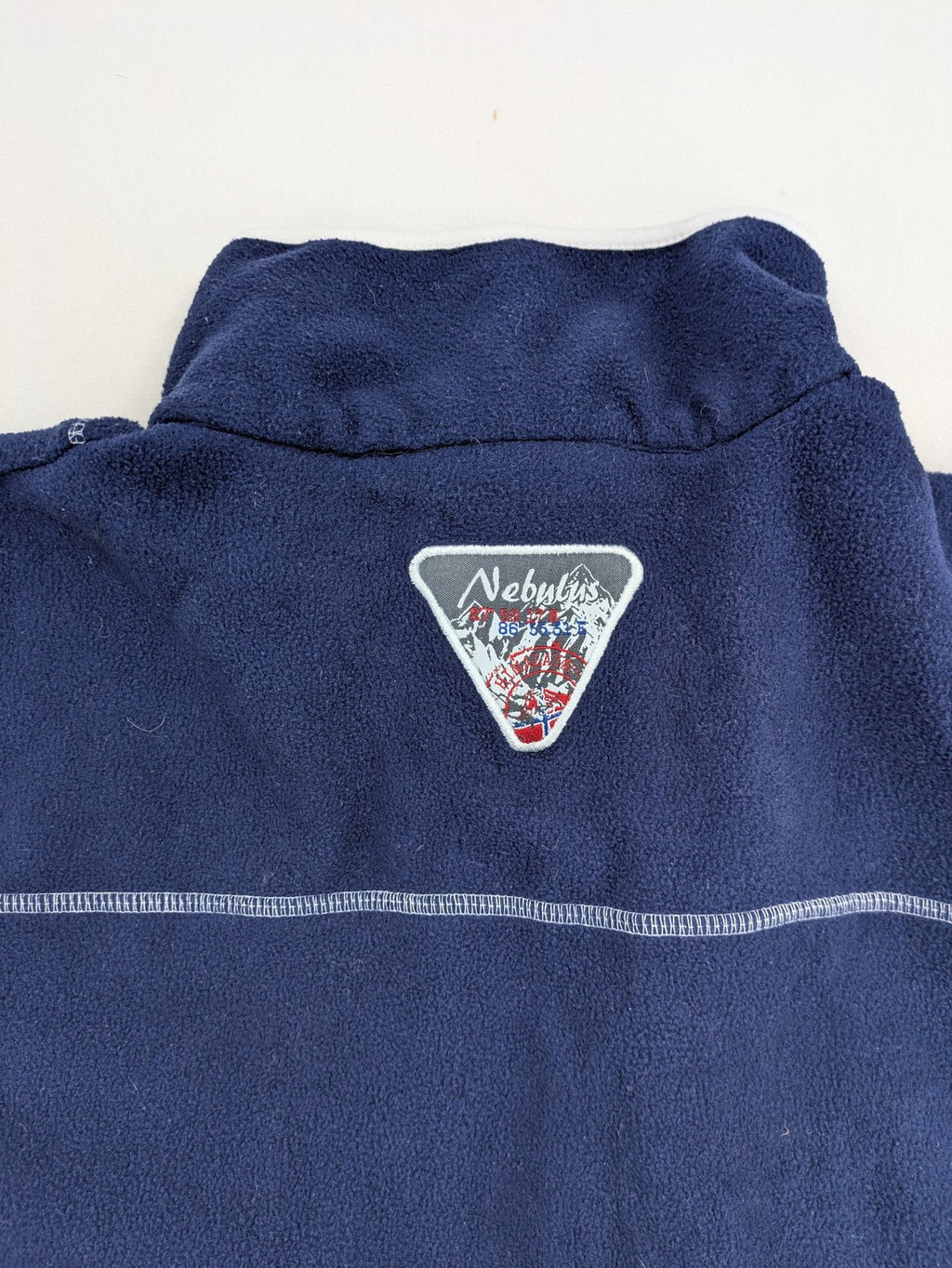 Nebulus navy turtle neck jumper with graphic print collar and "Himalaya Expedition" patch.