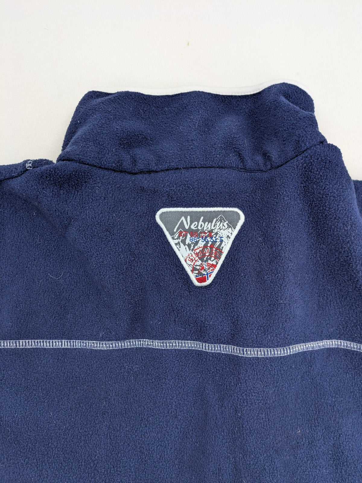 Nebulus navy turtle neck jumper with graphic print collar and "Himalaya Expedition" patch.