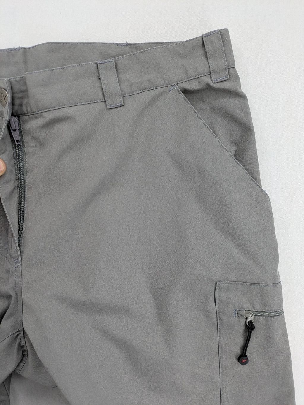 YETI grey cargo pants with multiple zippered pockets and durable material.