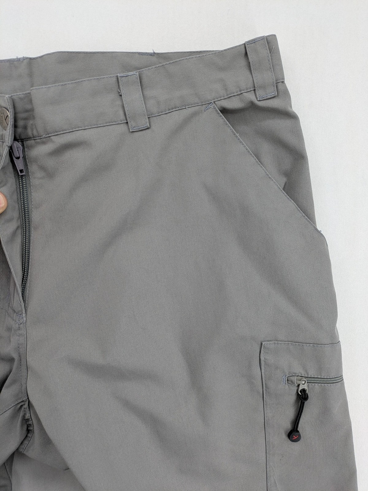 YETI grey cargo pants with multiple zippered pockets and durable material.