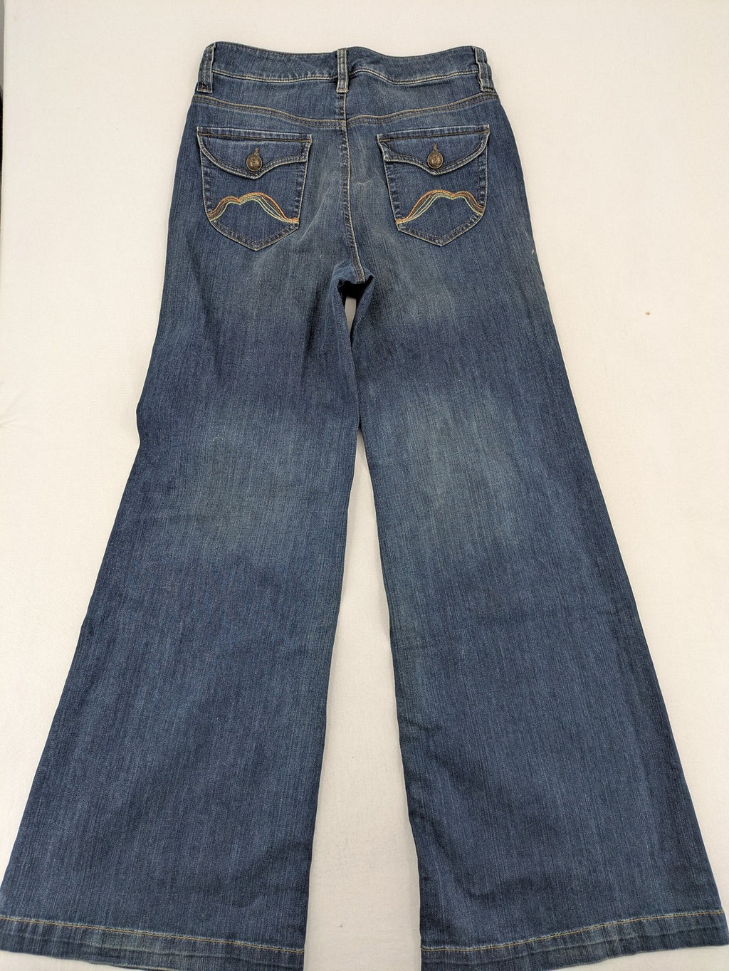 Rosner blue wide leg jeans with colorful embroidery on back pockets.
