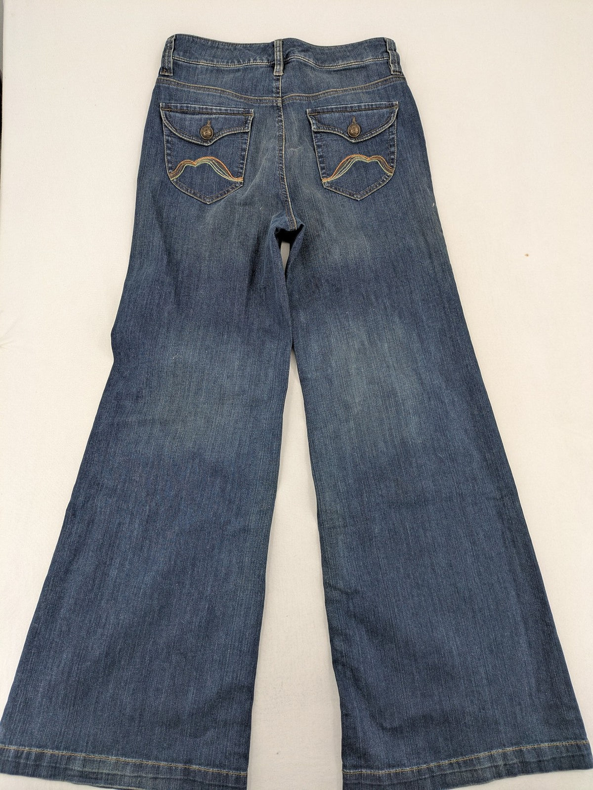 Rosner blue wide leg jeans with colorful embroidery on back pockets.