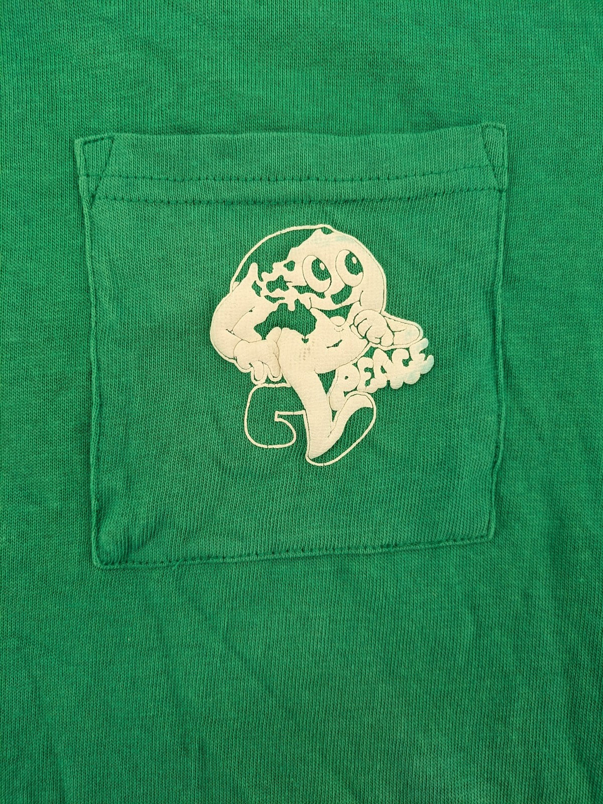Myla green graphic t-shirt with large peace earth print and front pocket design.