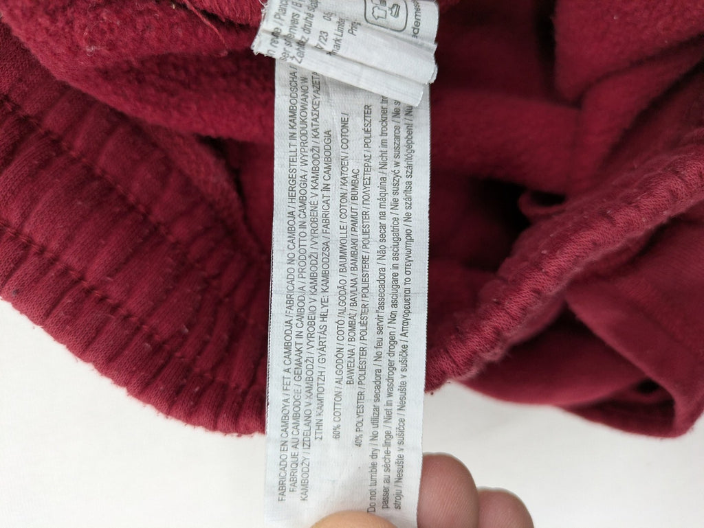 Harry Potter burgundy sweatpants featuring "HOGWARTS" print and Chibi graphic of Harry, Ron, Hermione.