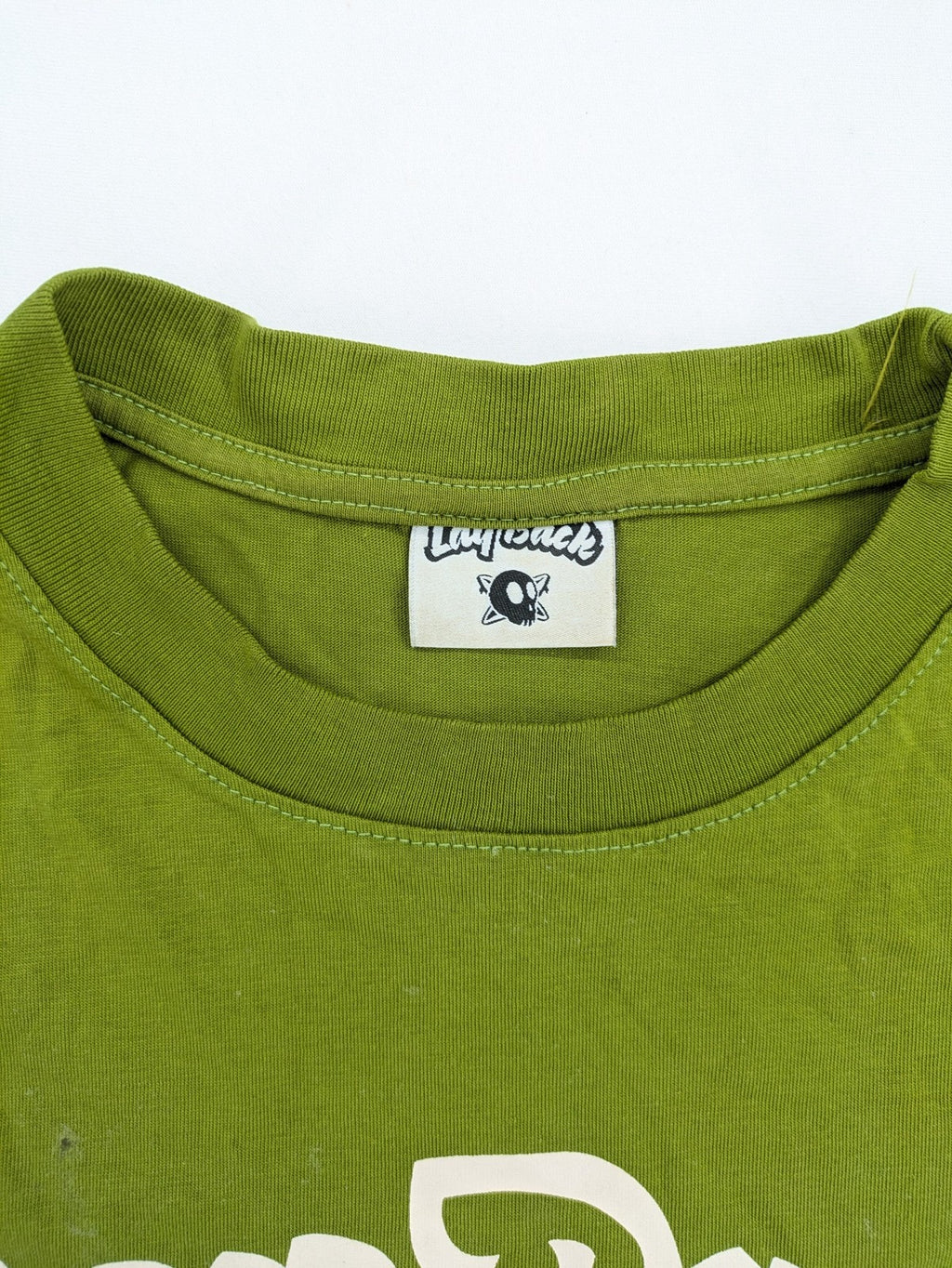 Lay Back green t-shirt with skull graphic, logo print, and short sleeves.