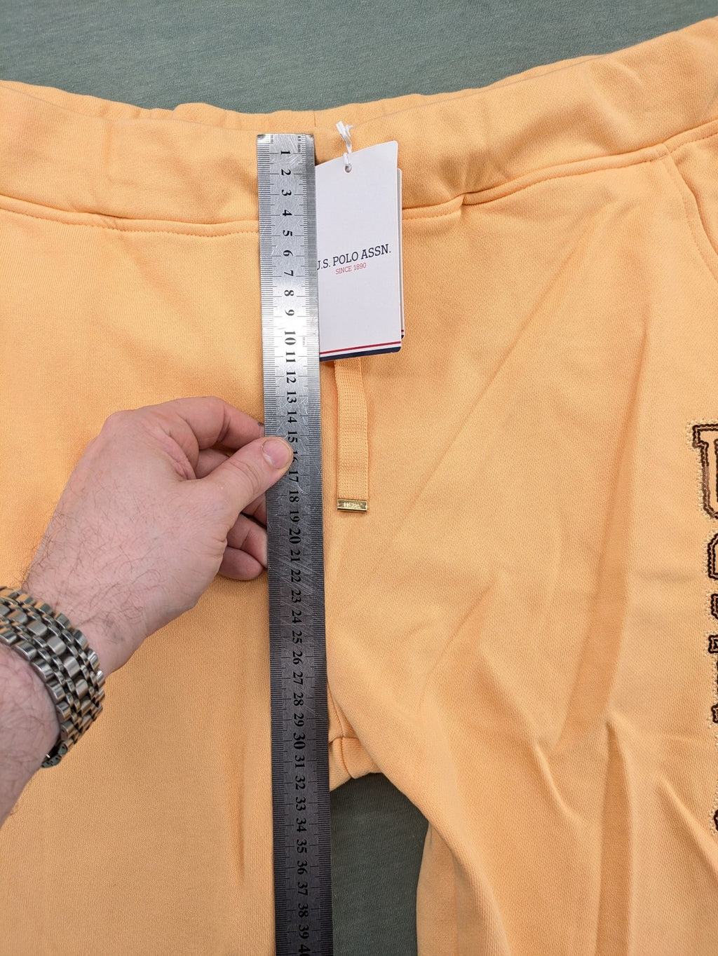 U.S. Polo Assn. orange sweatpants slim fit with sequin USPA logo on leg.