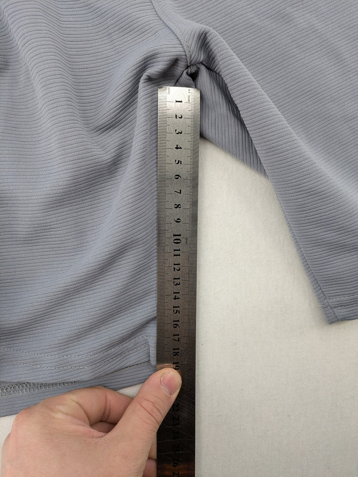 Nike grey shorts with Dri-FIT technology, elastic waistband, and zippered pockets.