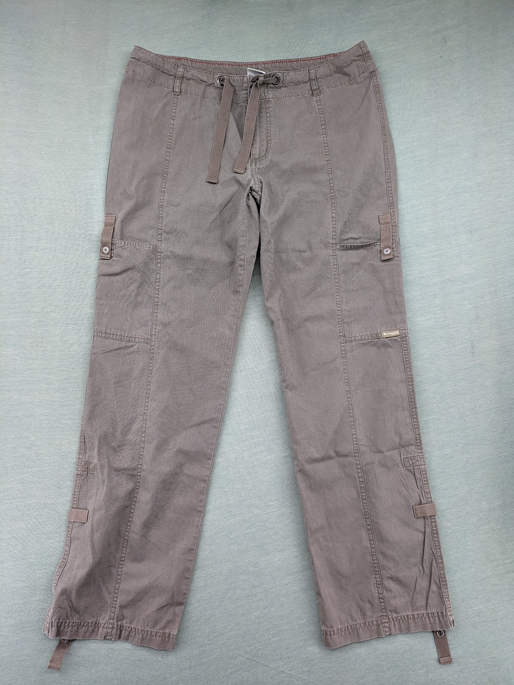 Columbia grey cargo pants with multiple pockets and drawstring waist, 100% cotton.