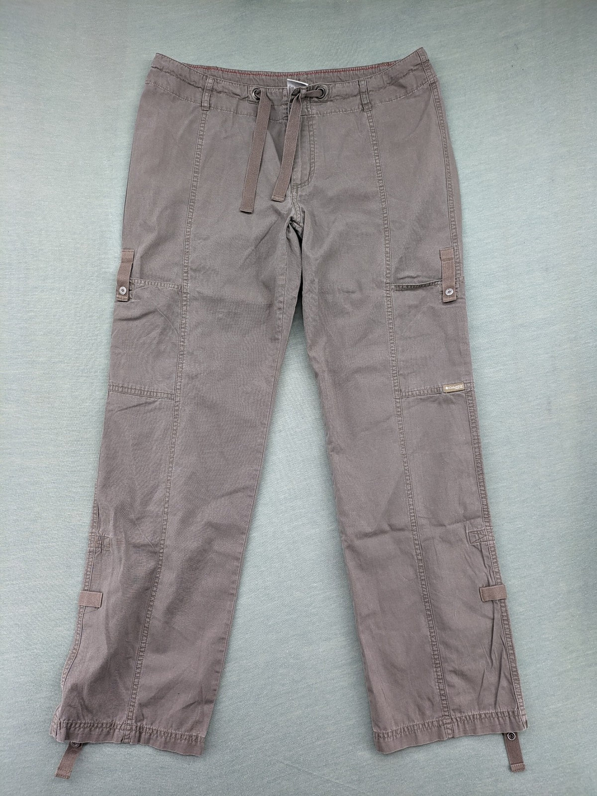 Columbia grey cargo pants with multiple pockets and drawstring waist, 100% cotton.