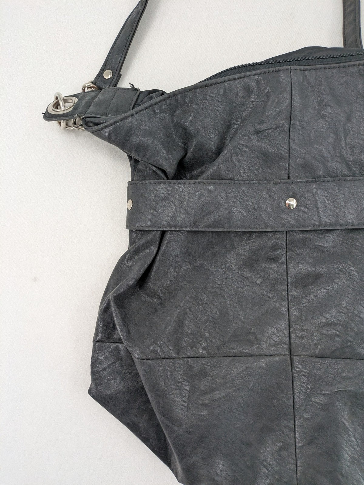 New Yorker black hobo handbag with silver chain details and large eyelets.