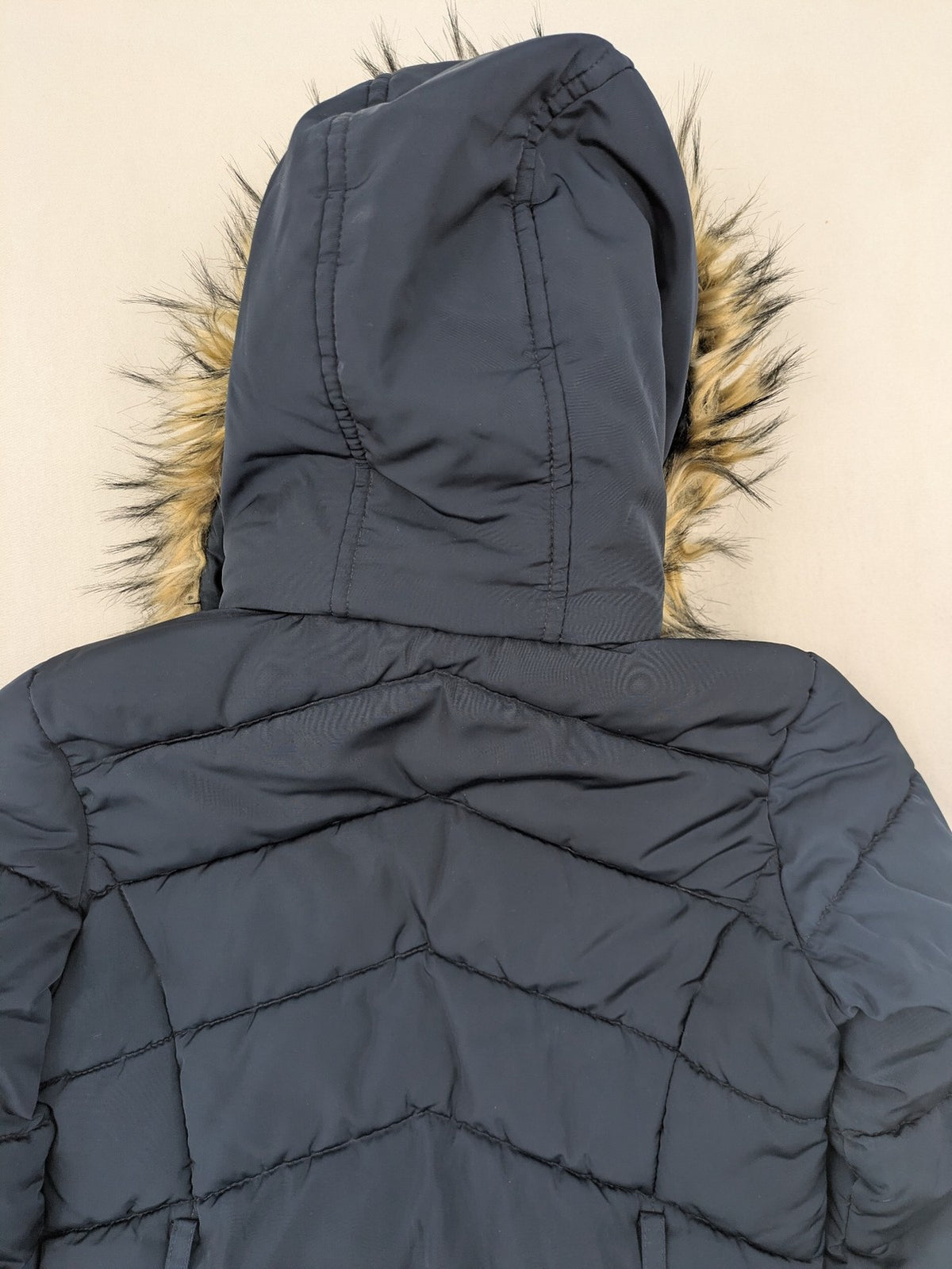 GEF cream coat with quilted design, fleece-lined hood, and faux fur trim.